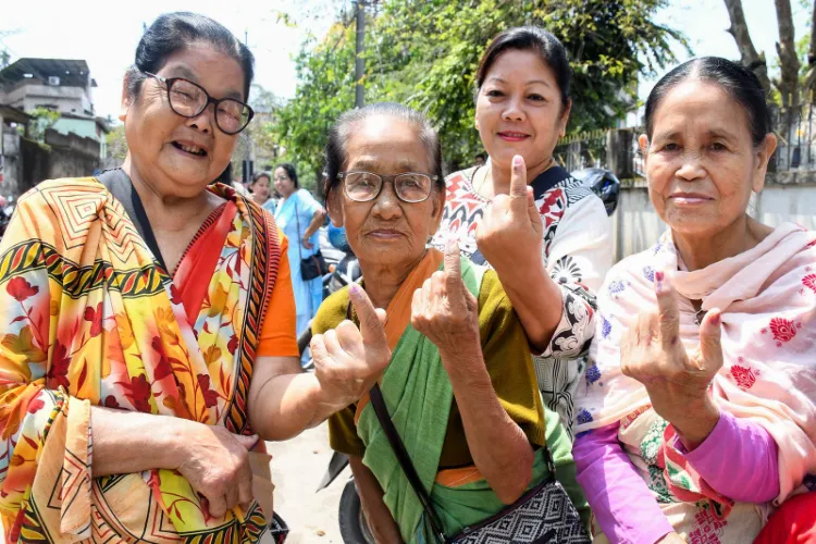 Voters show their inked fingers after casting their vote