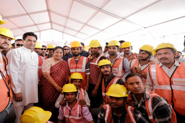 Delhi Chief Minister Rekha Gupta with labours at the Sant Nirankari Hospital construction site in Dhirpur