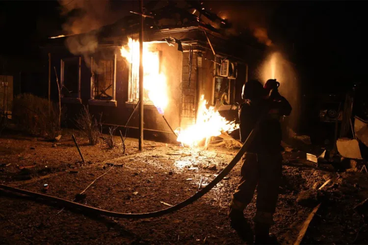 Firefighters battle flames after Russian drone strikes hit residential and critical infrastructure in Ukraine amid escalating overnight attacks. 