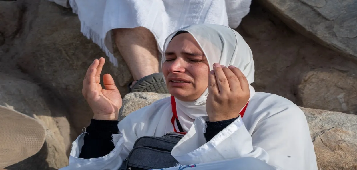 A woman praying during her Hajj pilgrimage