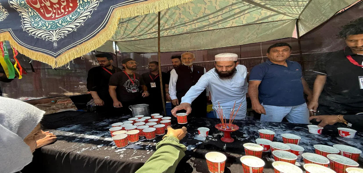 Shia and Sunni community members install a  juice and water counter in Srinagar downtown on first day of Muharram