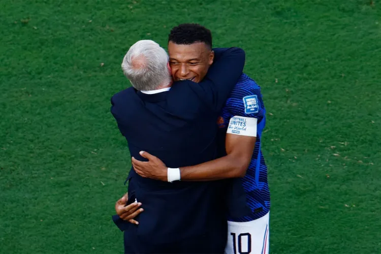 France's Kylian Mbappe celebrates scoring their first goal with coach Didier Deschamps
