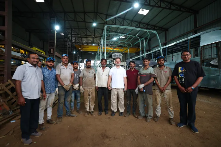 Leader of opposition in Lok Sabha, Rahul Gandhi with local bus and truck body-building workers