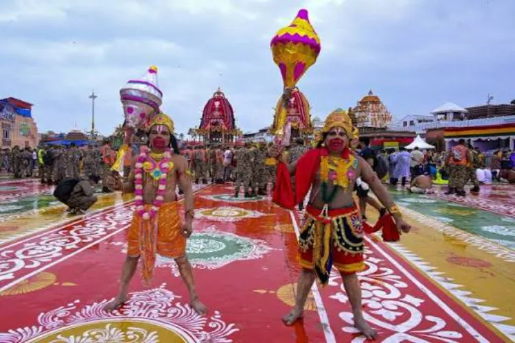 Puri: Artistes dressed as Hindu deities pose for photographs near the chariots of Lord Jagannath, Lord Balabhadra and Goddess Subhadra on the occasion of the Rath Yatra festival, in Puri, Odisha
