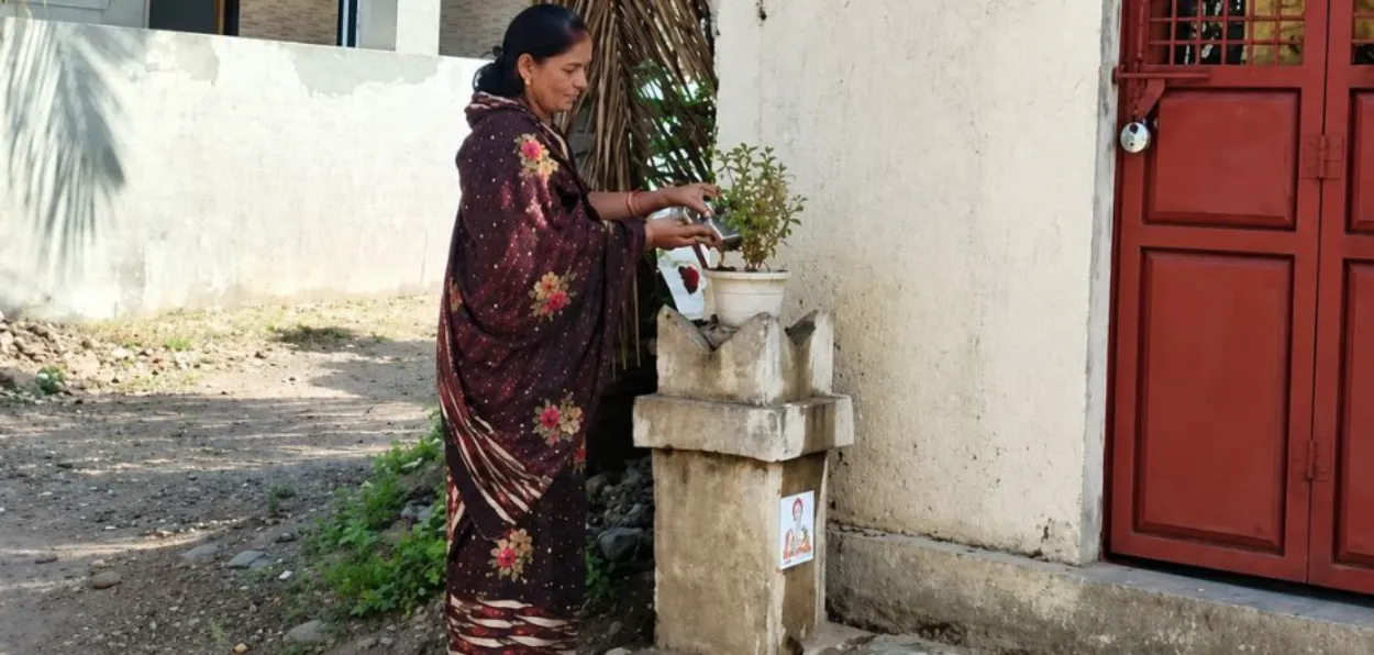 Anjum Mulani watering the Tulsi plant of neighbours