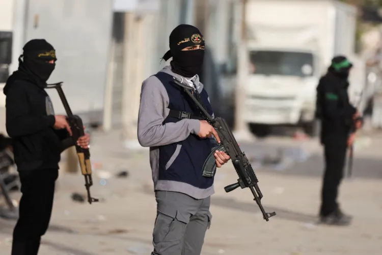 Militants from Hamas and Palestinian Islamic Jihad (PIJ) stand on a street during Eid al-Fitr in Gaza City 