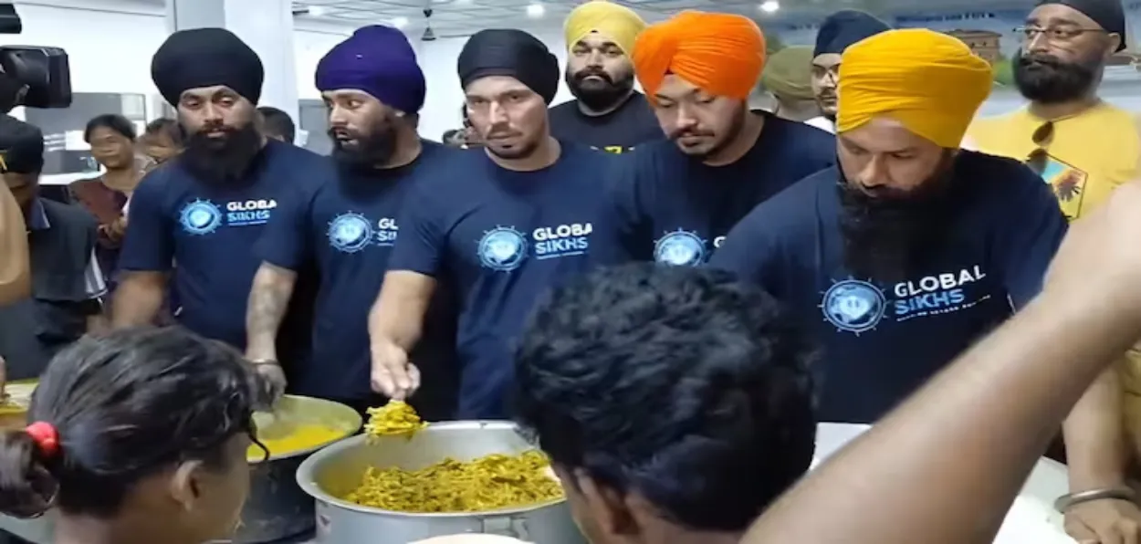 Actor Randeep Hooda serving food to Assam's flood-affected people (Image: Global Sikhs)
