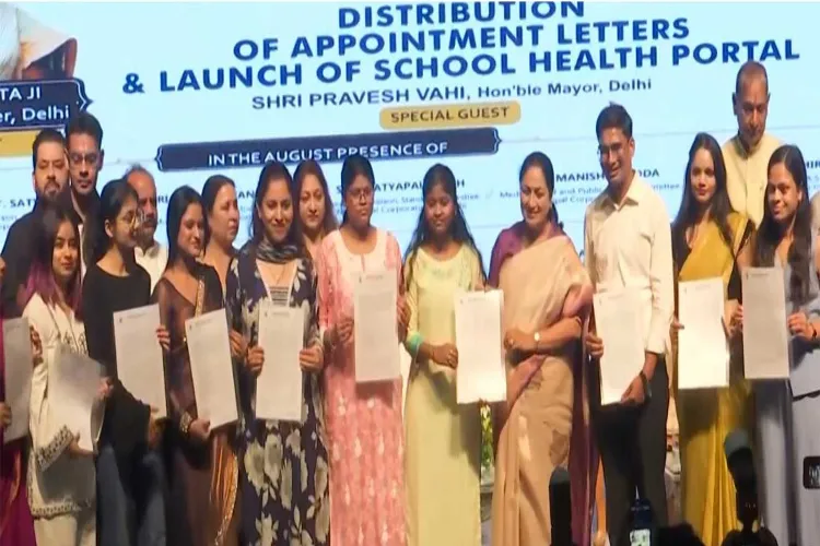 Delhi CM Rekha Gupta with recipients of appointment letters 