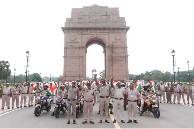 Delhi Police personnel participate in a Tiranga Rally along Kartavya Path