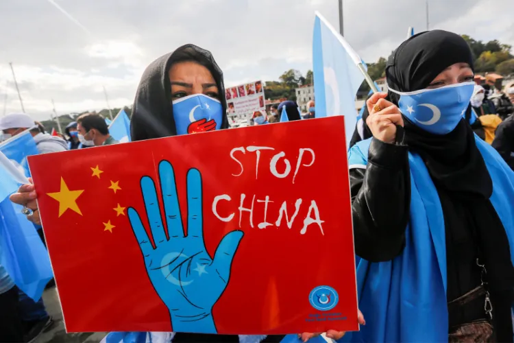 Ethnic Uyghur demonstrators take part in a protest against China