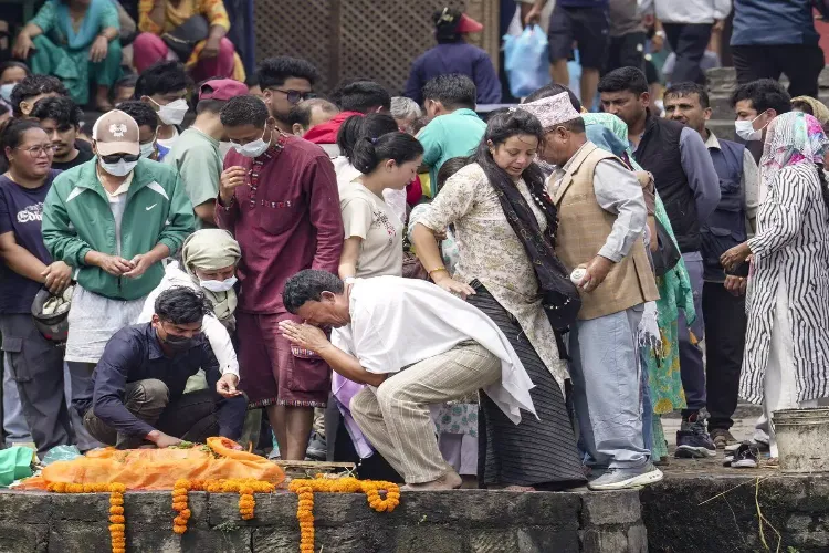 Family members mourn during symbolic funerals of their loved ones, who are flood victims still reported missing, in accordance with Nepali Hindu rites, at Pashupatinath temple in Kathmandu, Nepal