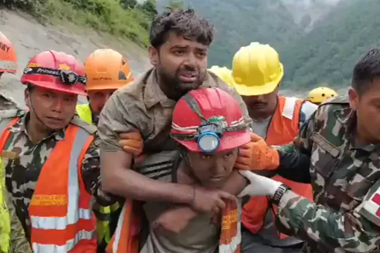 Rescue workers rescue one person from inside the tunnel of the Trishuli 3A hydel project 
