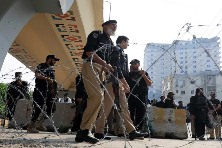 Police guard a road leading to Red Zone, in Peshawar, Khyber Pakhtunkhwa province, Pakistan
