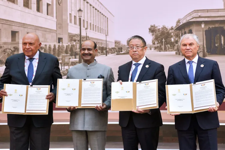 Lok Sabha Speaker Om Birla exchanges the Joint Declaration with China's National People's Congress Vice-Chairperson Zheng Jianbang during the conclusion of the 12th BRICS Parliamentary Forum 2026