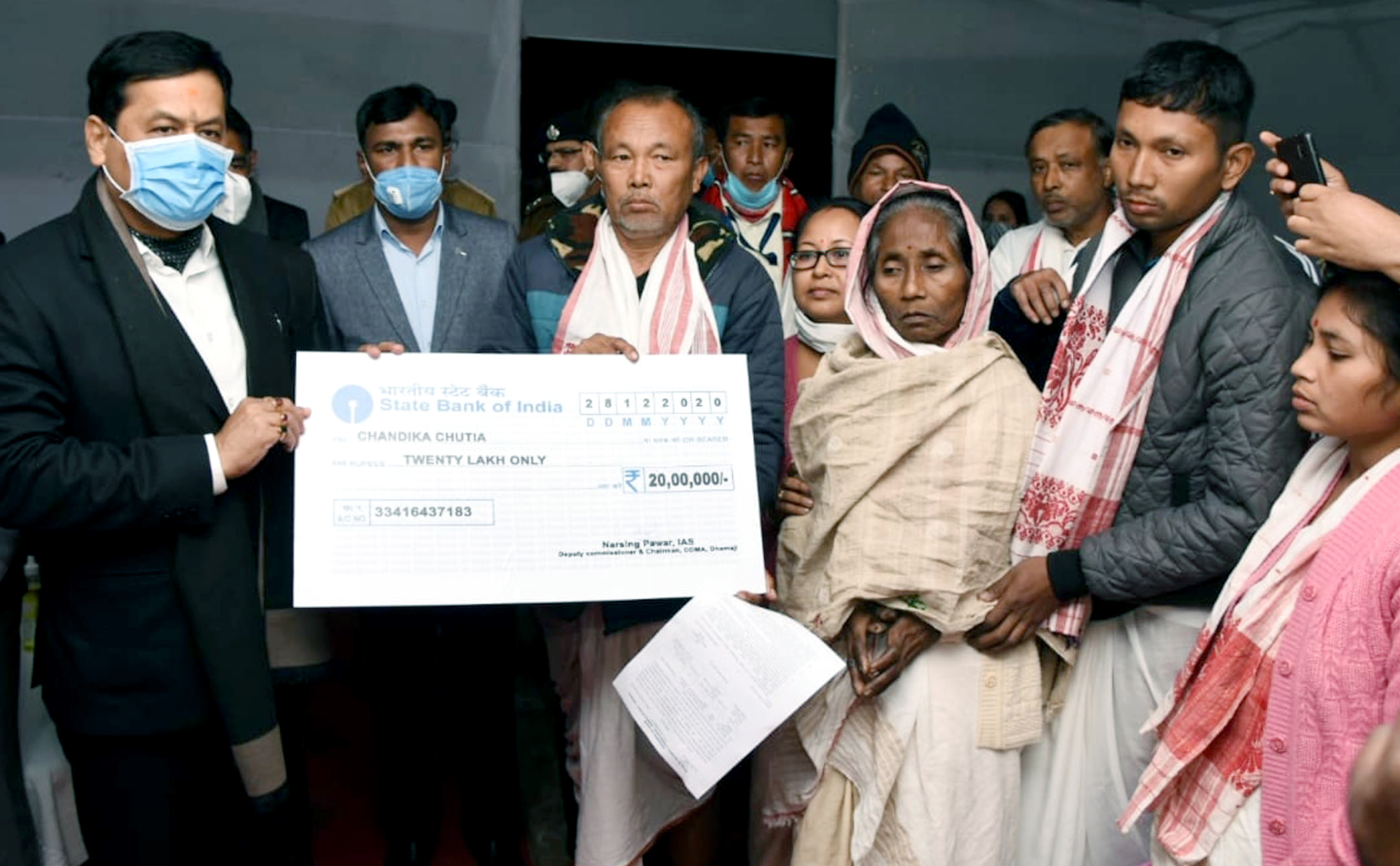 Assam Chief Minister Sarbananda Sonowal hands over cheque and commendation to the family of martyr CRPF jawan Mritunjoy Chutia