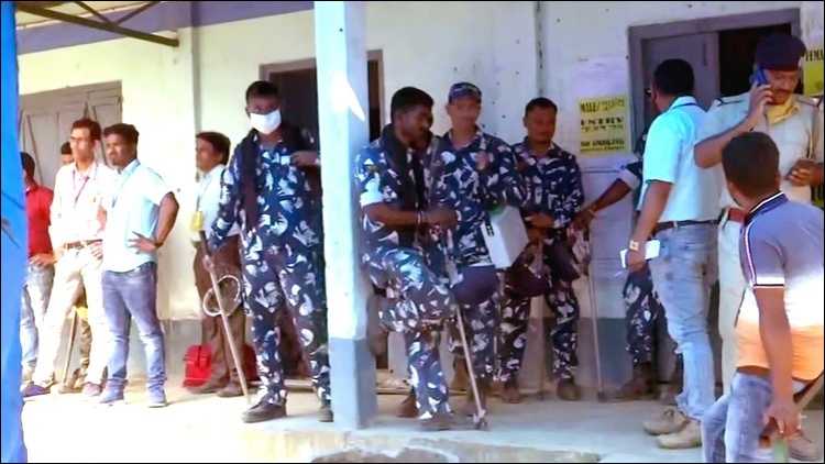 Paramilitary personnel stand guard as polling stops at a polling station of Sitalkuchi Assembly Constituency due to violence in Cooch Behar on April 9