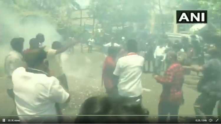 DMK party workers celebrating in large numbers with fireworks outside the party headquarters in Chennai