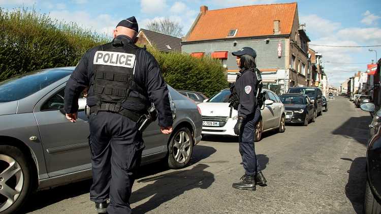 French police officers check vehicles in Wattrelos