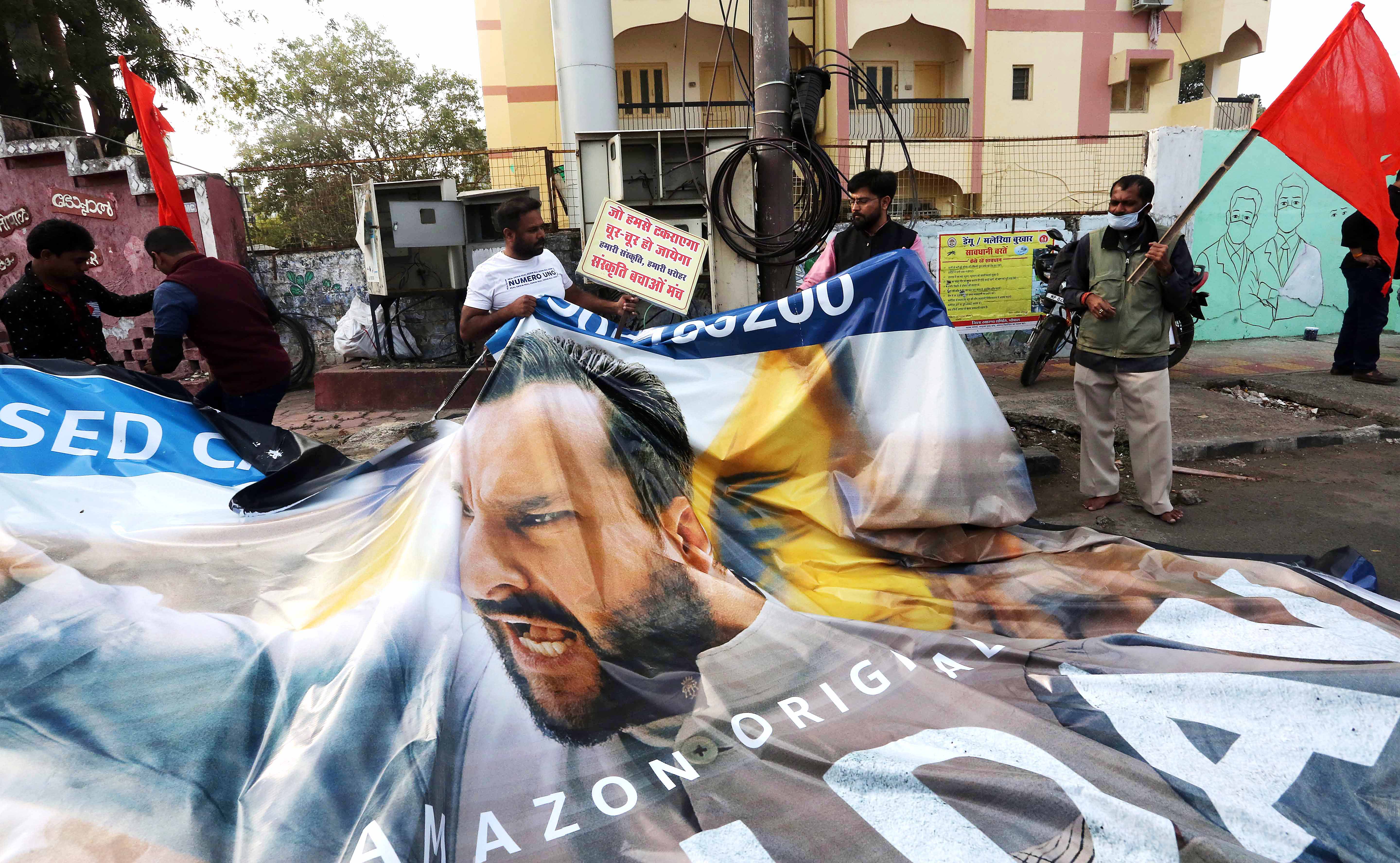 Sanskriti Bachao Manch supporters tear the banner of Bollywood Actor Saif Ali Khan during a demonstration against the Amazon web series 'Tandav', in Bhopal