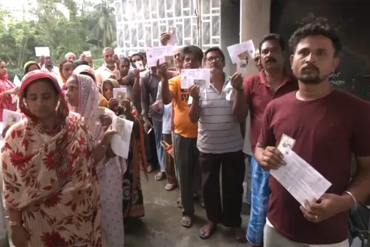 Voters queue up at a polling station to cast vote for the ongoing repolling at Falta assembly constituency