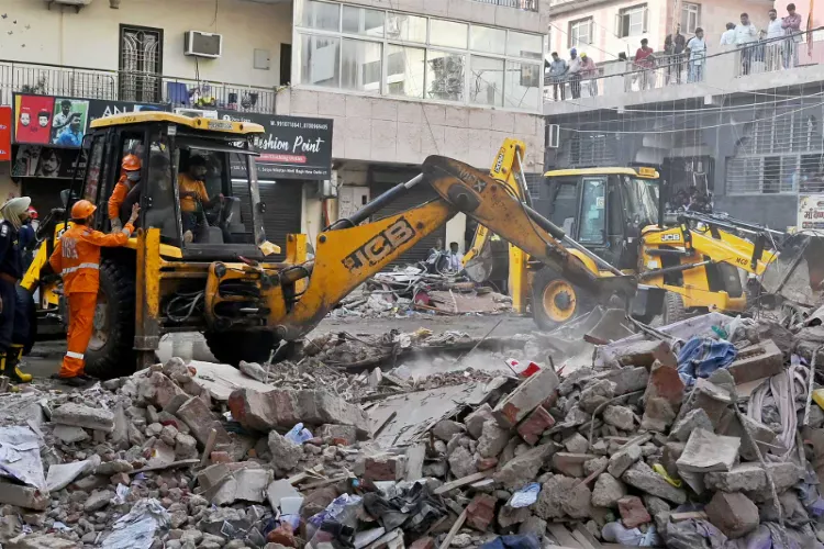 Rescue operations underway at the site of a building collapse near Satya Niketan