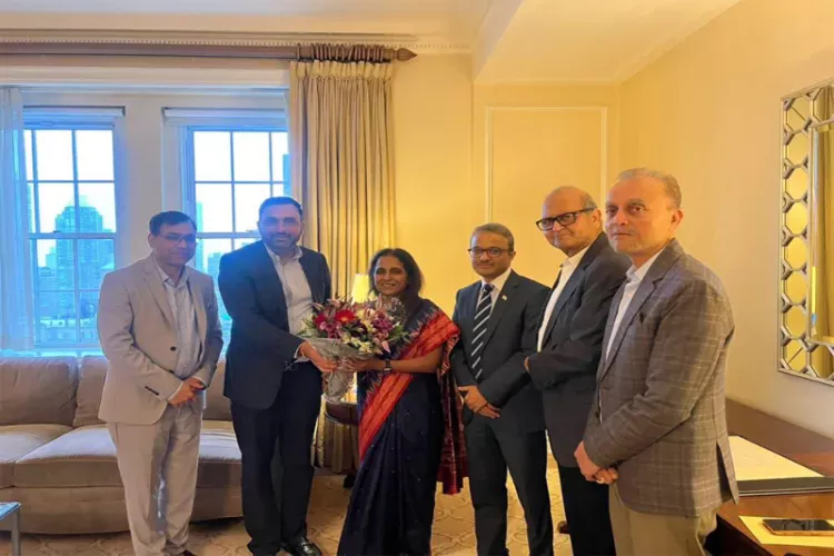 Sripriya Ranganathan, Secretary (CPV & OIA), Ministry of External Affairs, is greeted with a bouquet by Indian diaspora leaders during her interaction in New York, alongside Ambassador Binaya Srikanta Pradhan, Consul General of India in New York.